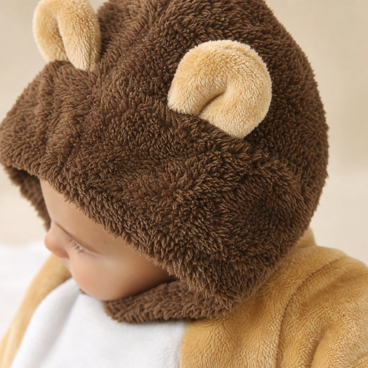 Close-up of the fluffy brown mane hood with round ears